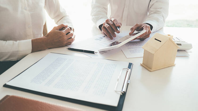 Business professionals reviewing project plans and documents at a desk