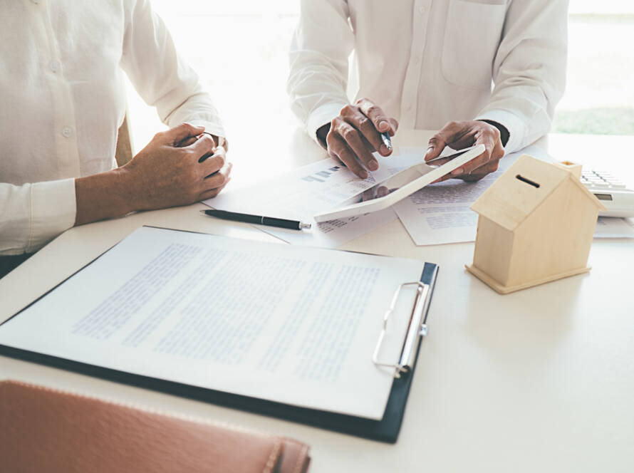 Business professionals reviewing project plans and documents at a desk