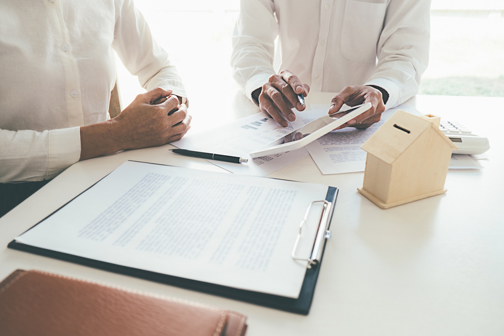 Business professionals reviewing project plans and documents at a desk