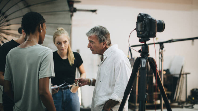 Video production director briefing crew and talent on set