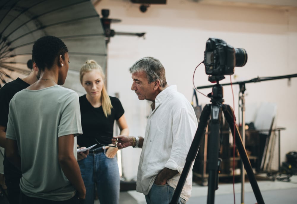 Video production director briefing crew and talent on set
